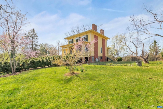 rear view of property featuring a yard