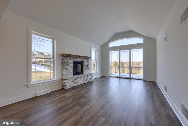 unfurnished living room featuring lofted ceiling, a fireplace, and dark hardwood / wood-style floors