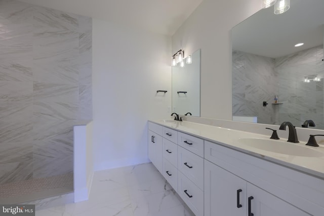 bathroom with vanity and tiled shower