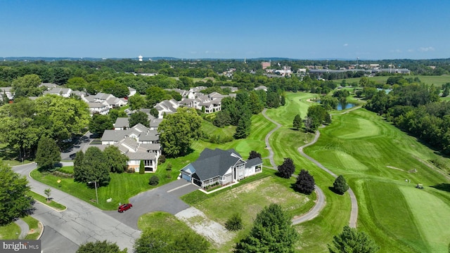 birds eye view of property with view of golf course and a residential view