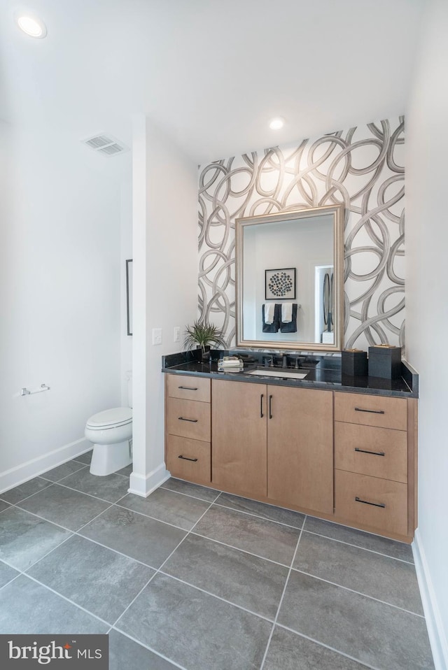 bathroom with vanity, toilet, and tile patterned flooring