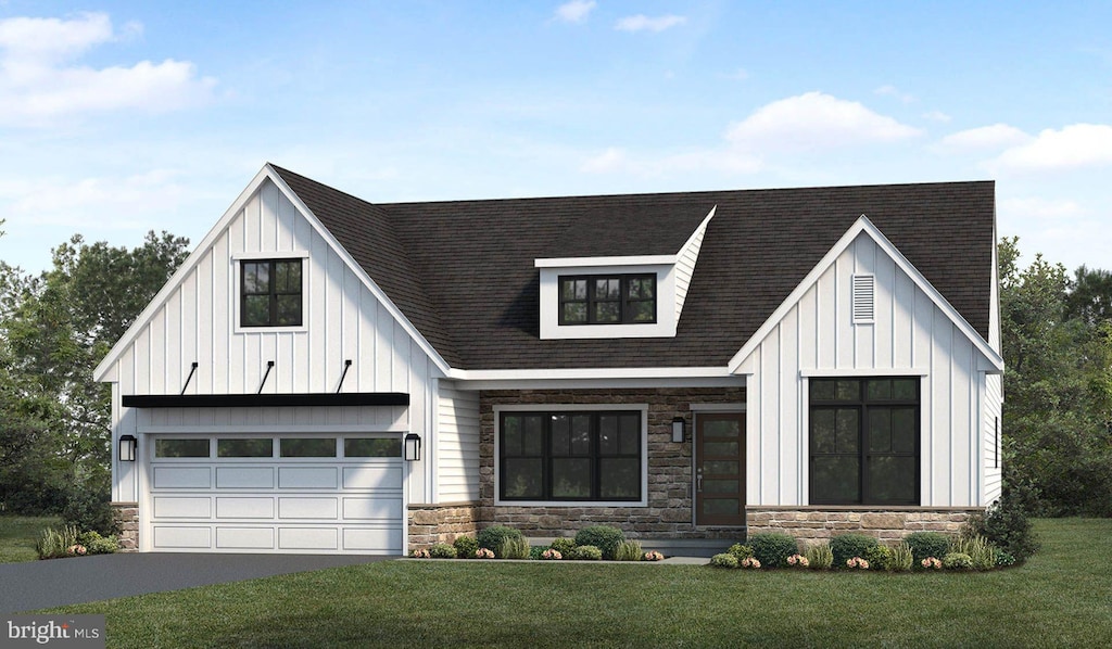 modern inspired farmhouse with a front lawn and a garage