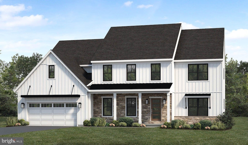 view of front of property featuring a front lawn and a garage