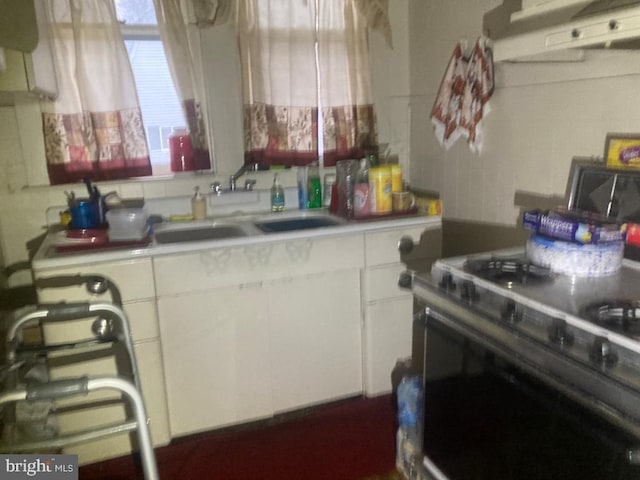 kitchen featuring fume extractor, white cabinets, electric range, and sink