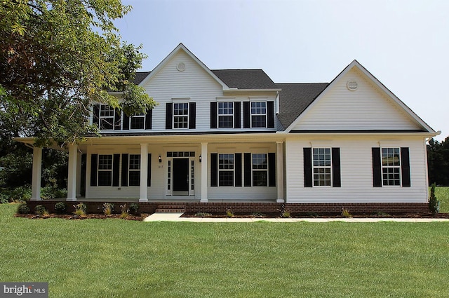 colonial house featuring a porch and a front lawn