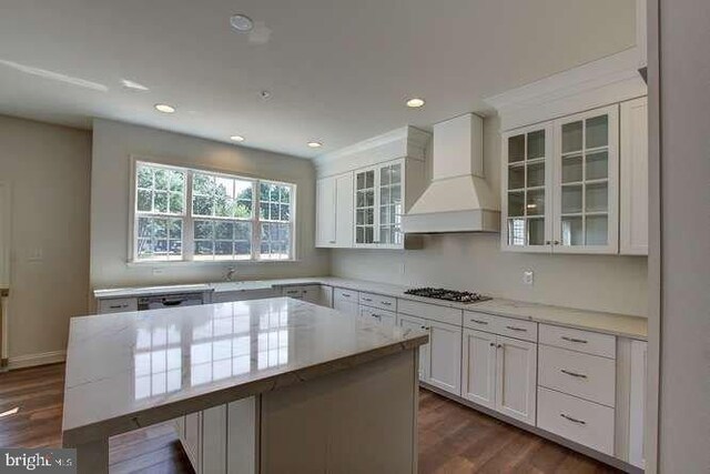 kitchen with custom exhaust hood, white cabinets, a center island, and gas stovetop