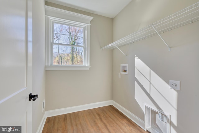 washroom with hookup for a washing machine, wood finished floors, baseboards, hookup for an electric dryer, and laundry area