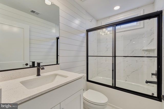 full bathroom with vanity, visible vents, enclosed tub / shower combo, wood walls, and toilet