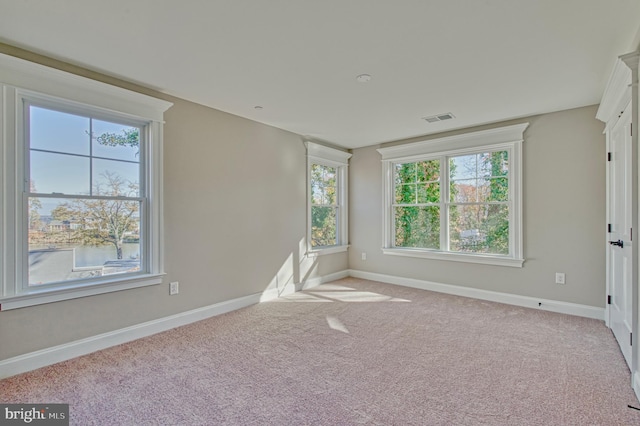 unfurnished room featuring carpet flooring, baseboards, and visible vents