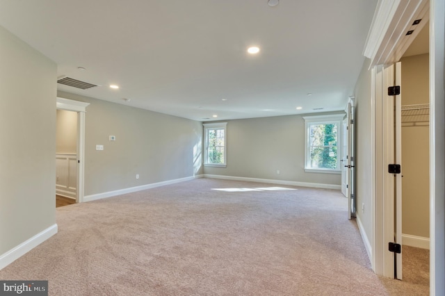 unfurnished room with recessed lighting, carpet, visible vents, and baseboards