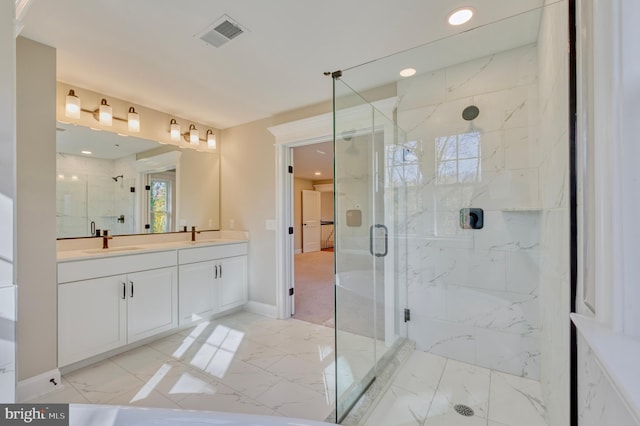 full bath featuring a sink, visible vents, a marble finish shower, and marble finish floor