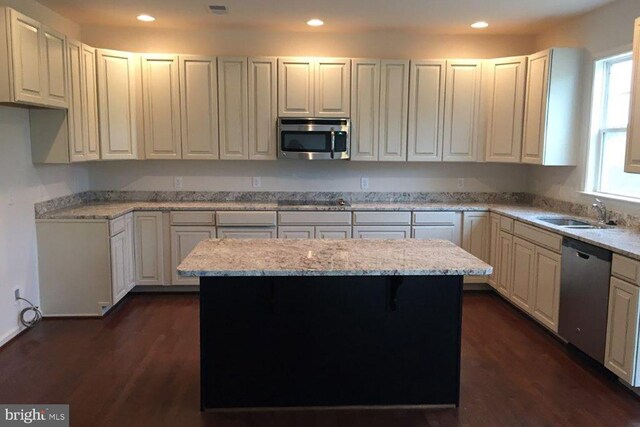 kitchen with dark wood finished floors, recessed lighting, appliances with stainless steel finishes, and a sink