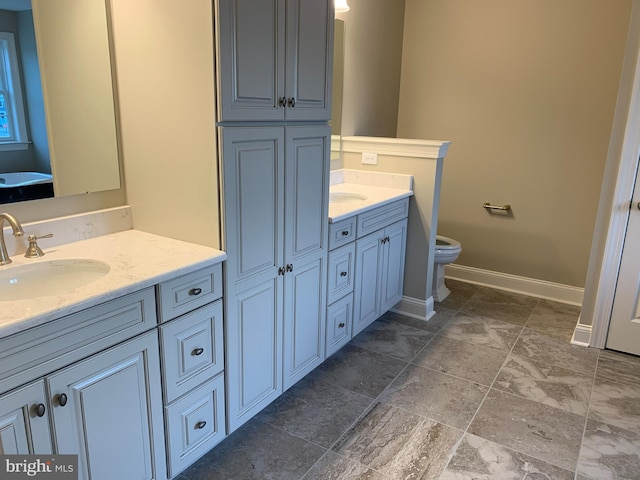 bathroom featuring toilet, tile floors, and vanity