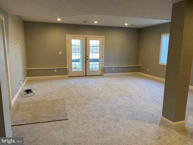 carpeted spare room with french doors