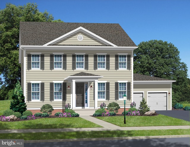 colonial inspired home featuring a front lawn and a garage