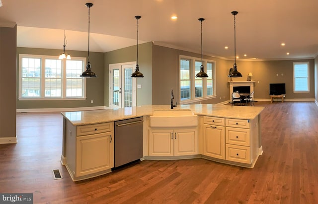 kitchen with hanging light fixtures, hardwood / wood-style floors, and dishwasher