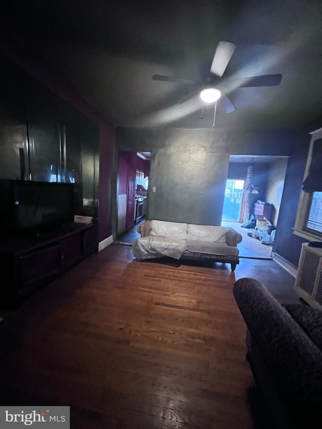 living room with ceiling fan and dark hardwood / wood-style floors