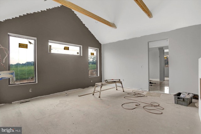 spare room featuring a wealth of natural light, beamed ceiling, and high vaulted ceiling