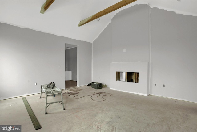 unfurnished living room featuring a fireplace and lofted ceiling with beams