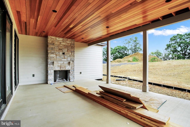 view of patio with an outdoor stone fireplace