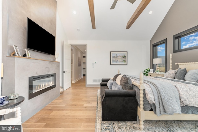 bedroom with ceiling fan, light hardwood / wood-style floors, and lofted ceiling with beams