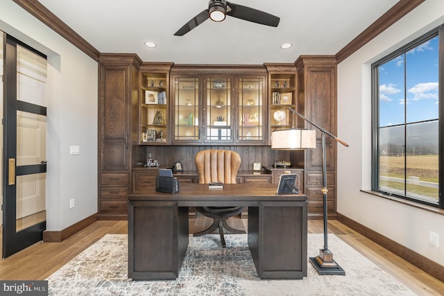 office area with light hardwood / wood-style flooring, ceiling fan, and crown molding