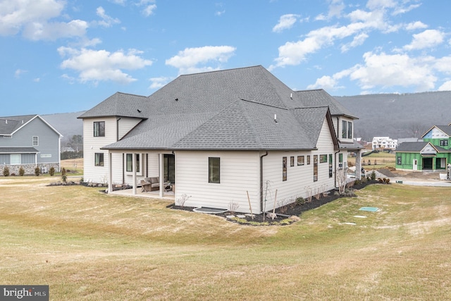 back of property featuring a yard and a patio