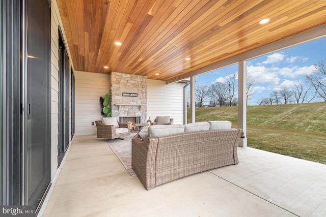 view of patio / terrace with an outdoor living space with a fireplace