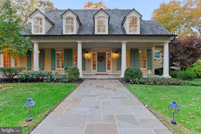 view of front facade with a front yard and covered porch