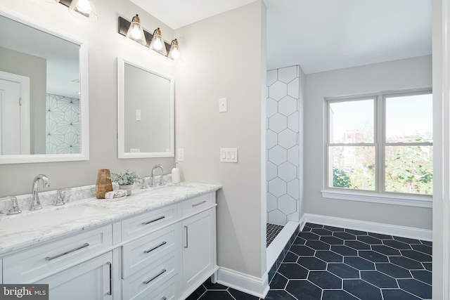 bathroom with oversized vanity, double sink, walk in shower, and tile flooring