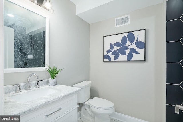 bathroom with toilet and vanity