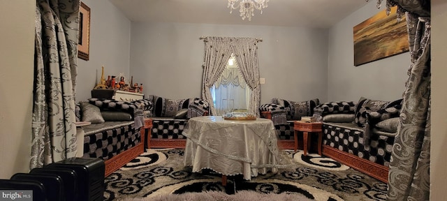 living area with carpet flooring and a notable chandelier