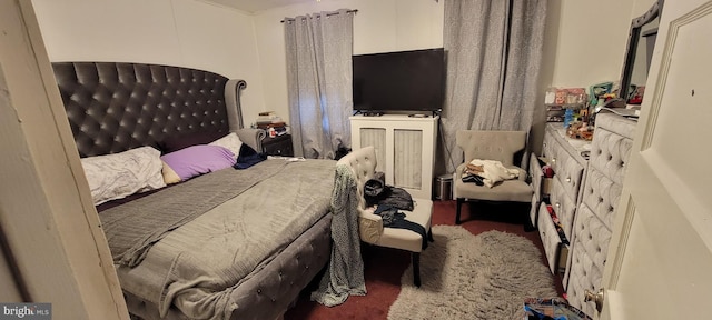 bedroom with dark colored carpet and ornamental molding