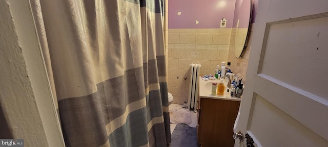 bathroom featuring tile walls and radiator