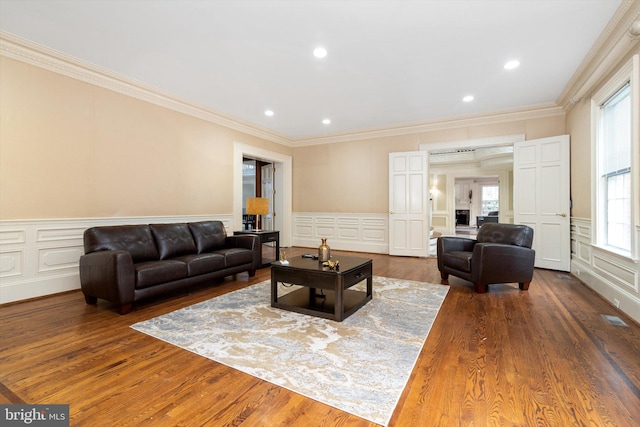 living room featuring dark hardwood / wood-style floors and ornamental molding