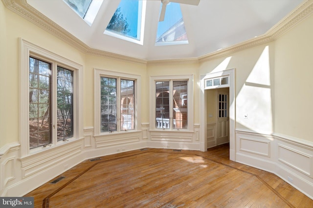 unfurnished sunroom featuring a skylight