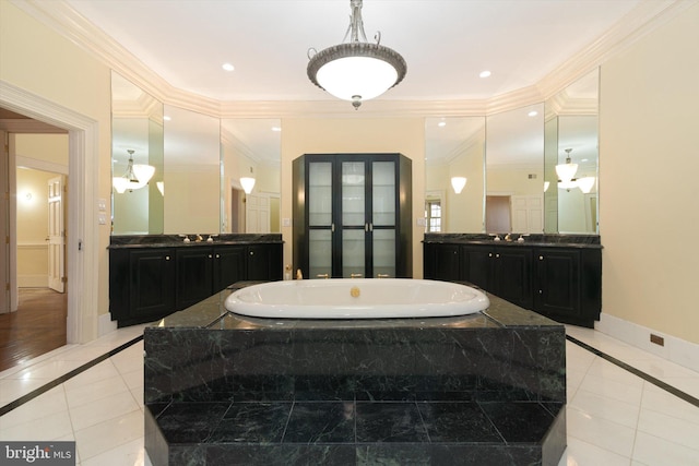 bathroom with tile patterned flooring, vanity, crown molding, and tiled tub