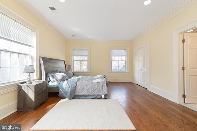 bedroom with wood-type flooring and ornamental molding