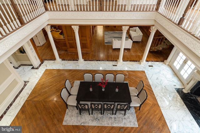 dining room with wood-type flooring and ornate columns