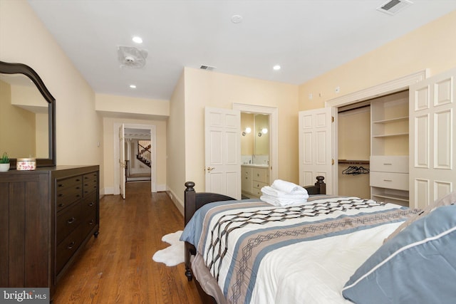 bedroom featuring ensuite bathroom, dark hardwood / wood-style flooring, a walk in closet, and a closet