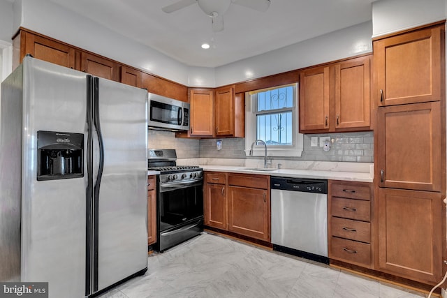 kitchen with backsplash, appliances with stainless steel finishes, ceiling fan, sink, and light tile flooring