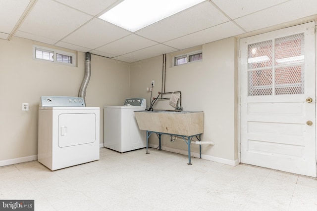 washroom with light tile flooring, separate washer and dryer, and sink