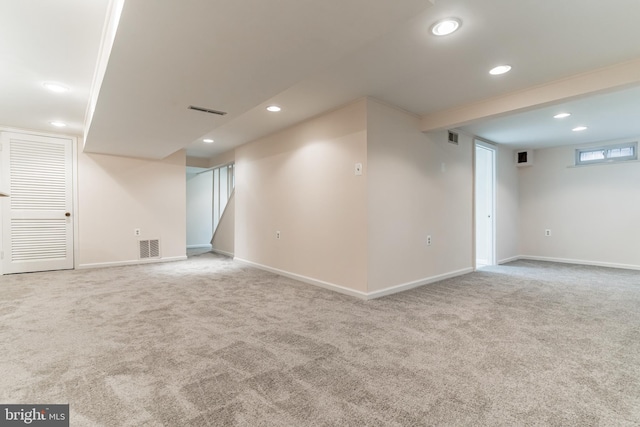 basement featuring light colored carpet