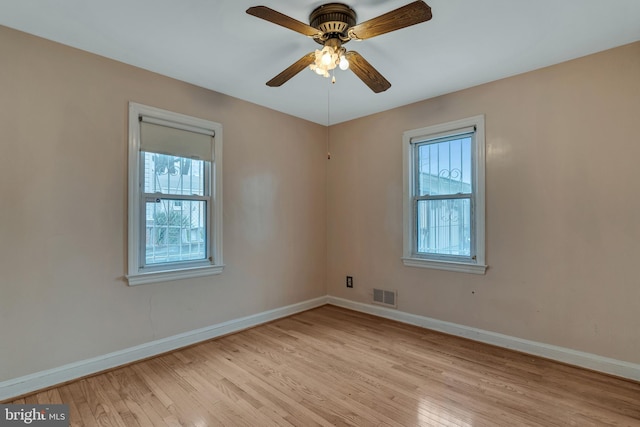 empty room featuring ceiling fan and light hardwood / wood-style floors