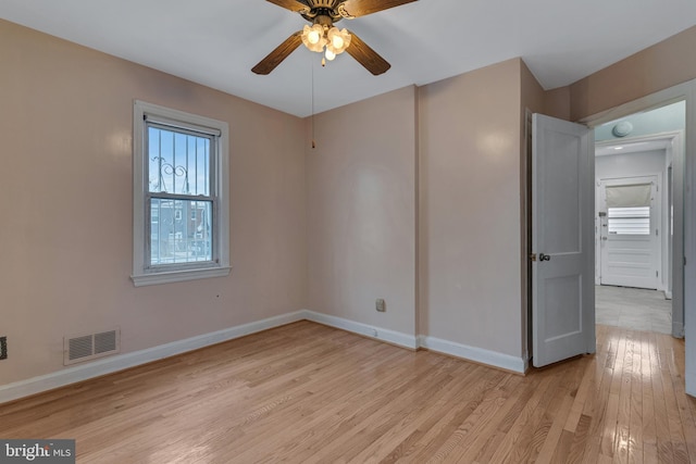 empty room featuring ceiling fan and light hardwood / wood-style flooring