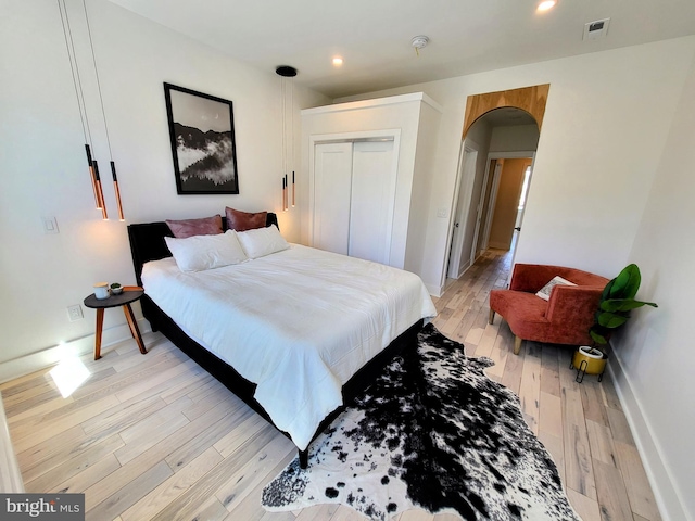 bedroom with a closet and light wood-type flooring