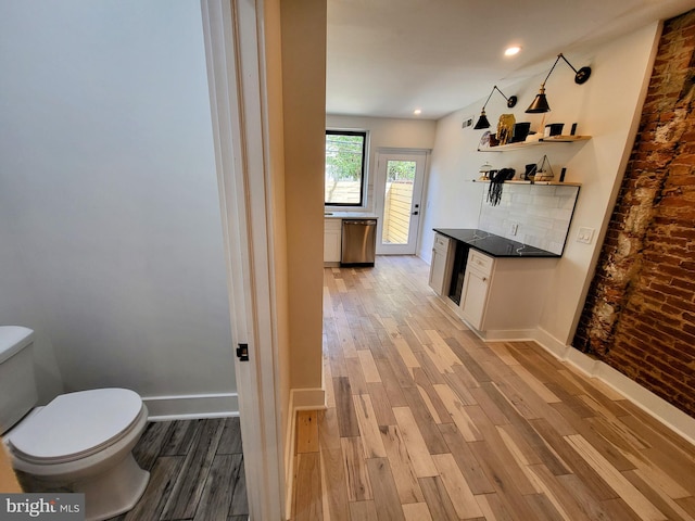 bathroom featuring vanity, toilet, tasteful backsplash, and hardwood / wood-style floors