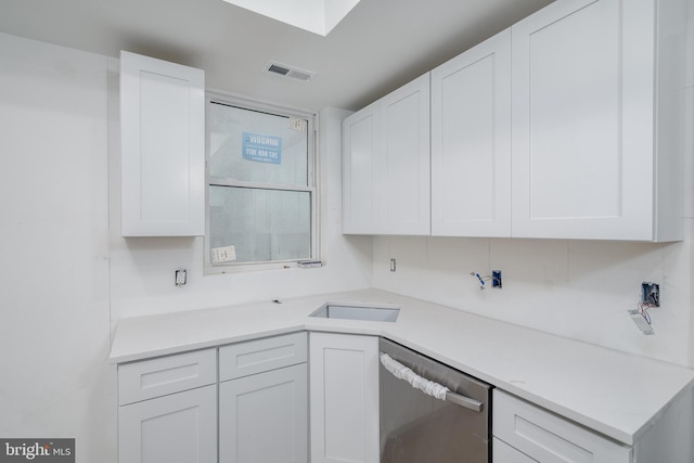 kitchen with white cabinetry and stainless steel dishwasher