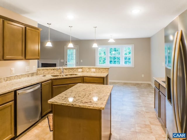 kitchen featuring hanging light fixtures, a center island, appliances with stainless steel finishes, and sink