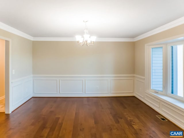 spare room with a notable chandelier, a wealth of natural light, and dark wood-type flooring